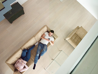 Image showing couple on sofa using mobile phones top view