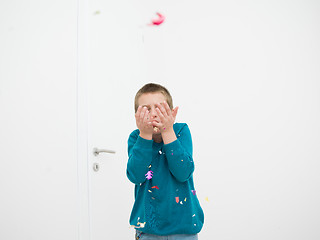 Image showing kid blowing confetti