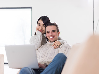 Image showing multiethnic couple using laptop computers