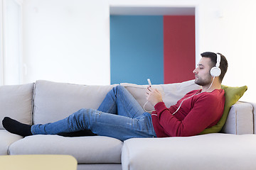 Image showing man enjoying music through headphones