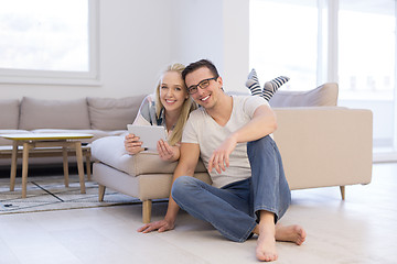 Image showing couple relaxing at  home with tablet computers