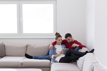 Image showing couple relaxing at  home with tablet computers