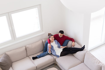 Image showing couple relaxing at  home with tablet computers