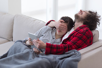 Image showing couple relaxing at  home with tablet computers