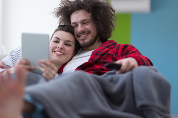 Image showing couple relaxing at  home with tablet computers