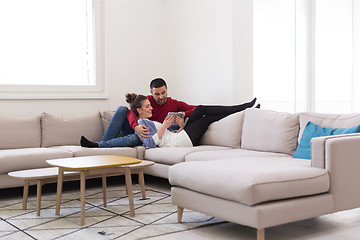 Image showing couple relaxing at  home with tablet computers