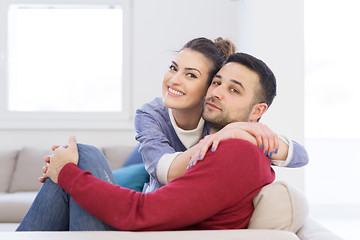 Image showing couple hugging and relaxing on sofa