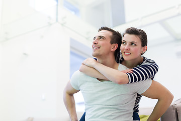 Image showing handsome man piggybacking his girlfriend