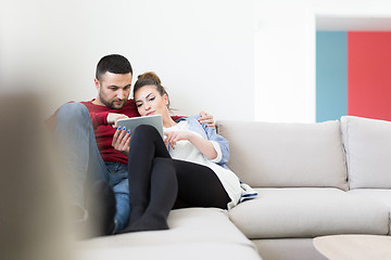 Image showing couple relaxing at  home with tablet computers