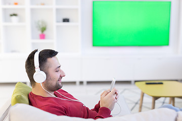 Image showing man enjoying music through headphones