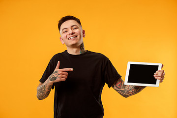 Image showing Portrait of a confident casual man showing blank screen of laptop