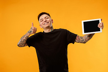 Image showing Portrait of a confident casual man showing blank screen of laptop