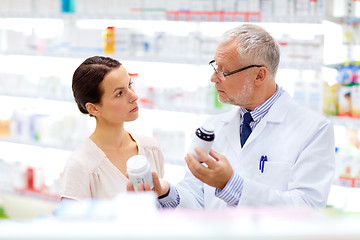 Image showing apothecary and woman with drug at pharmacy