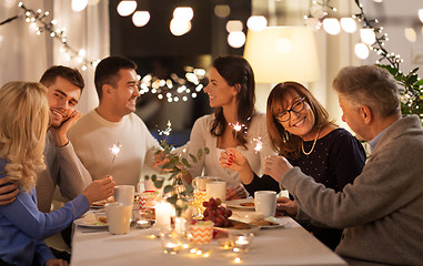 Image showing family with sparklers having dinner party at home