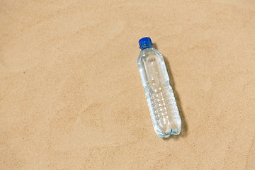 Image showing bottle of water on beach sand