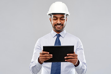 Image showing architect or businessman in helmet with tablet pc