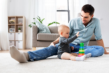 Image showing father playing with little baby daughter at home