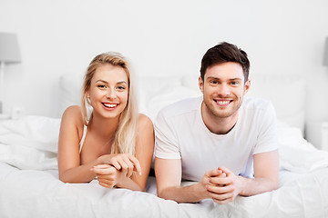 Image showing happy couple lying in bed at home