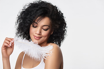 Image showing Beautiful mixed race woman holding white ostrich feather