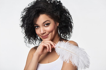 Image showing Beautiful mixed race woman holding white ostrich feather