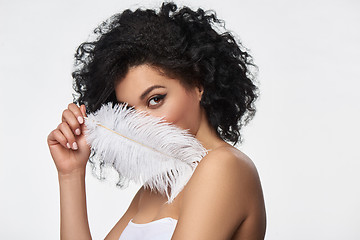 Image showing Beautiful mixed race woman holding white ostrich feather