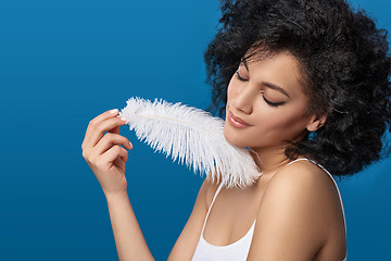 Image showing Beautiful mixed race woman holding white ostrich feather