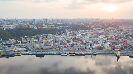 Image showing The panoramic bird\'s eye view shooting from drone of the Podol district, the right bank of the Dnieper River and centre of Kiev, Ukraine at summer sunset on the background of the cloudy sky.