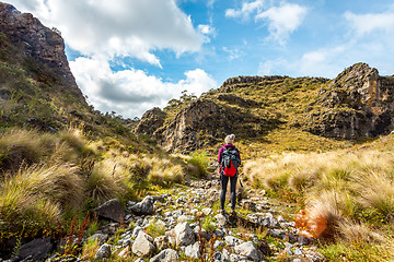 Image showing Hiker in Snowy Mountains walking through a dry gorge