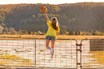 Image showing Aussie woman standing on a rural farm gate