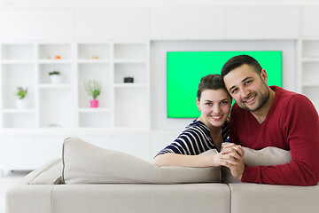 Image showing couple hugging and relaxing on sofa