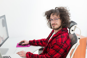 Image showing graphic designer in bathrobe working at home