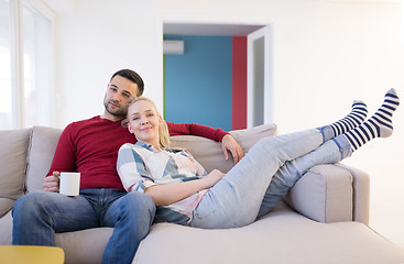 Image showing couple hugging and relaxing on sofa