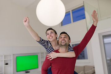 Image showing handsome man piggybacking his girlfriend