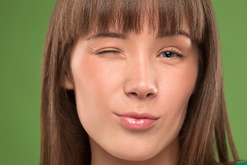 Image showing Close up portrait of a pretty young woman winking