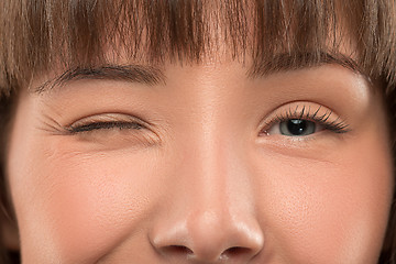 Image showing Close up portrait of a pretty young woman winking