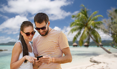 Image showing happy couple with smartphone in summer