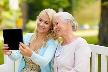 Image showing daughter with tablet pc and senior mother at park