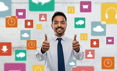 Image showing indian businessman shows thumbs up over app icons