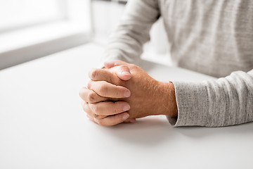 Image showing senior man hands on table