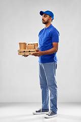 Image showing happy indian delivery man with food and drinks