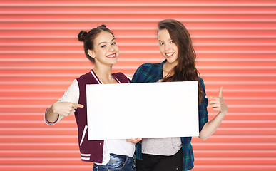 Image showing happy teenage girls or friends holding white board