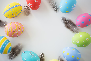Image showing close up of colored easter eggs and feathers