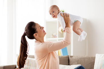 Image showing happy mother playing with little baby boy at home