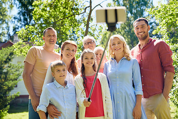 Image showing happy family taking selfie in summer garden