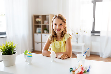 Image showing happy girl with easter eggs and colors at home