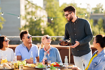 Image showing friends at bbq party on rooftop in summer