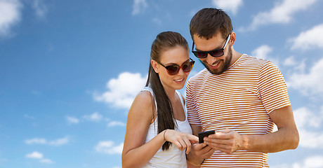 Image showing happy couple with smartphone in summer
