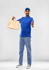 Image showing happy indian delivery man with food in paper bag