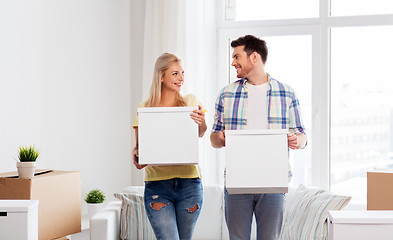 Image showing happy couple with boxes moving to new home