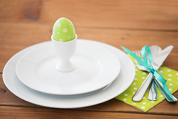 Image showing easter egg in cup holder, plates and cutlery